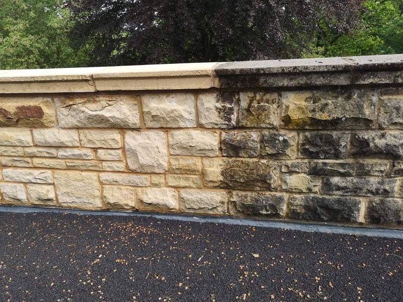 Half sand blasted stone wall to show the difference.