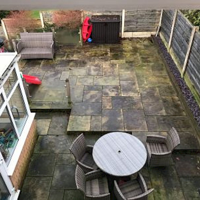 Before picture of a dirty back garden.